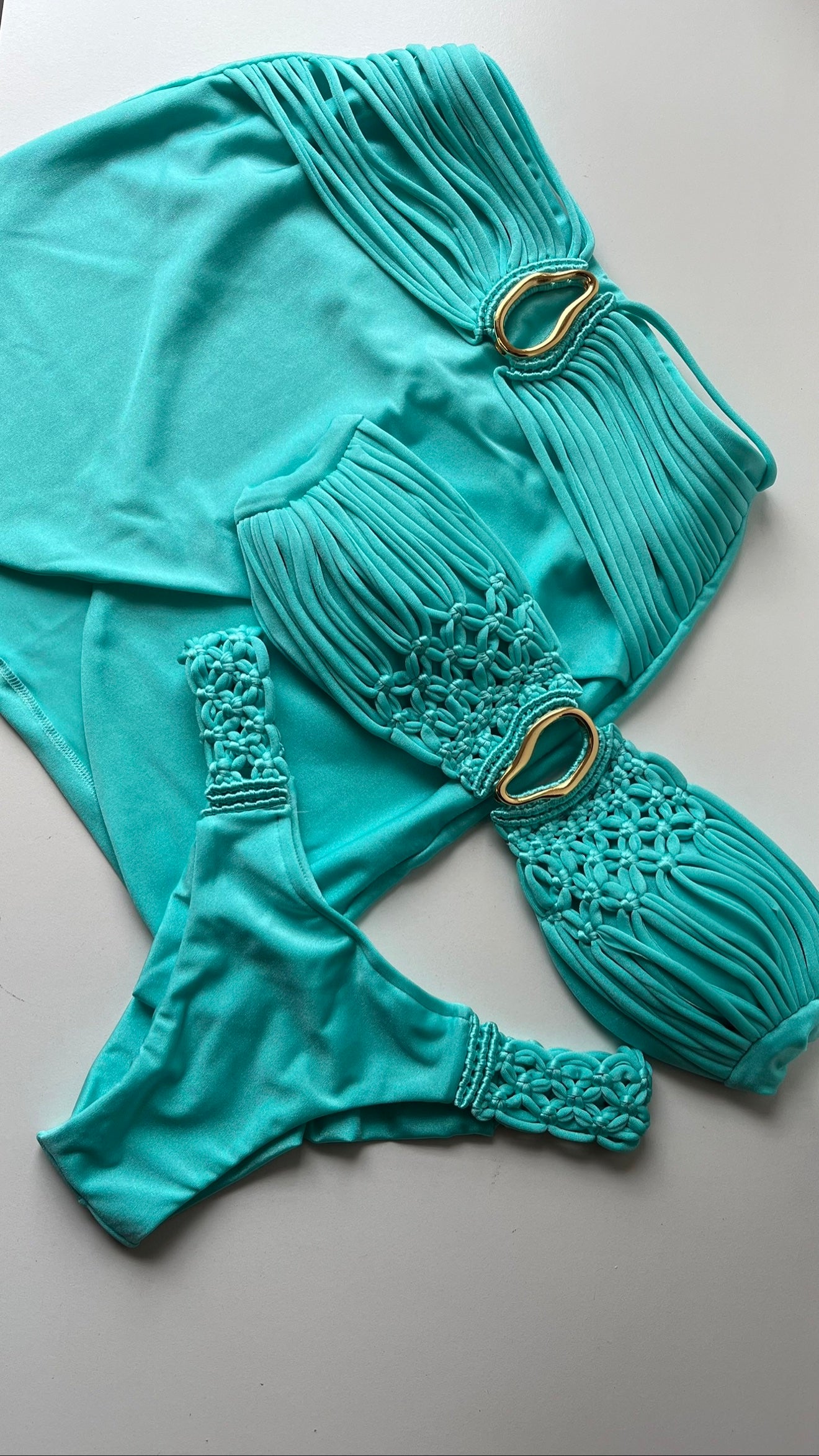 Ibiza Tiffany blue wrap skirt and macramé bikini set flat lay