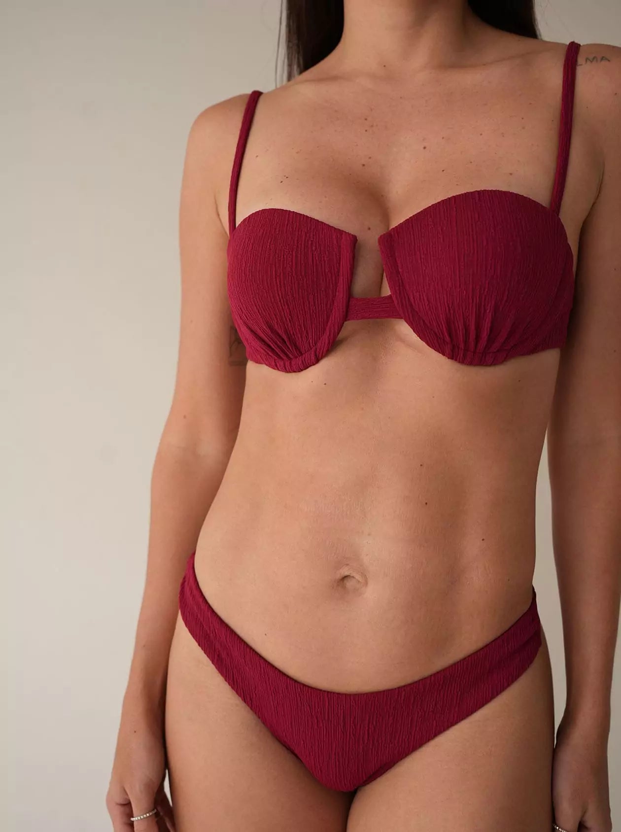 Close-up of structured burgundy bikini top highlighting cleavage fit