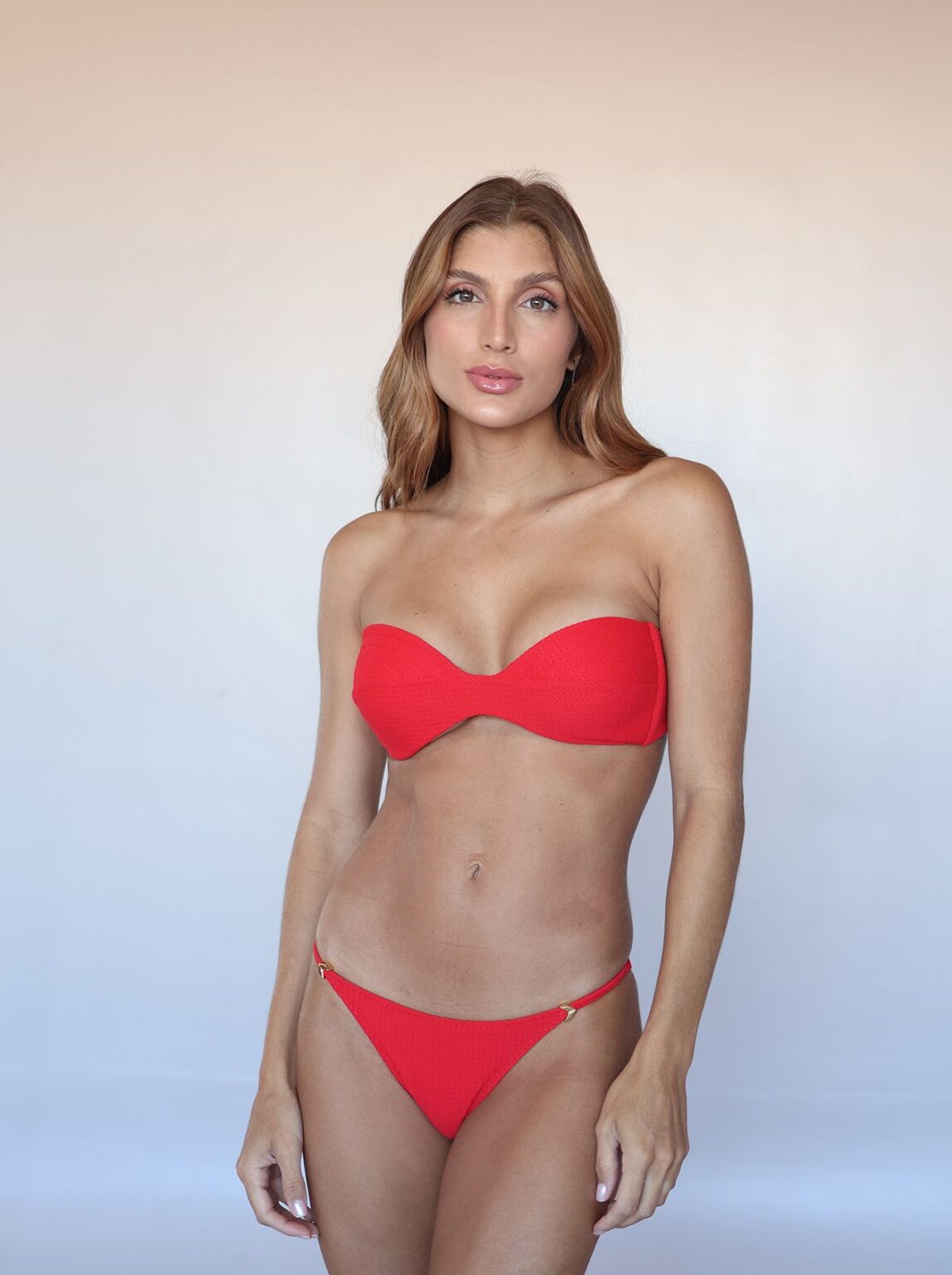 Front view of the Aurora Bandeau Bikini Set in textured Poppy Red fabric with gold-tone hardware.