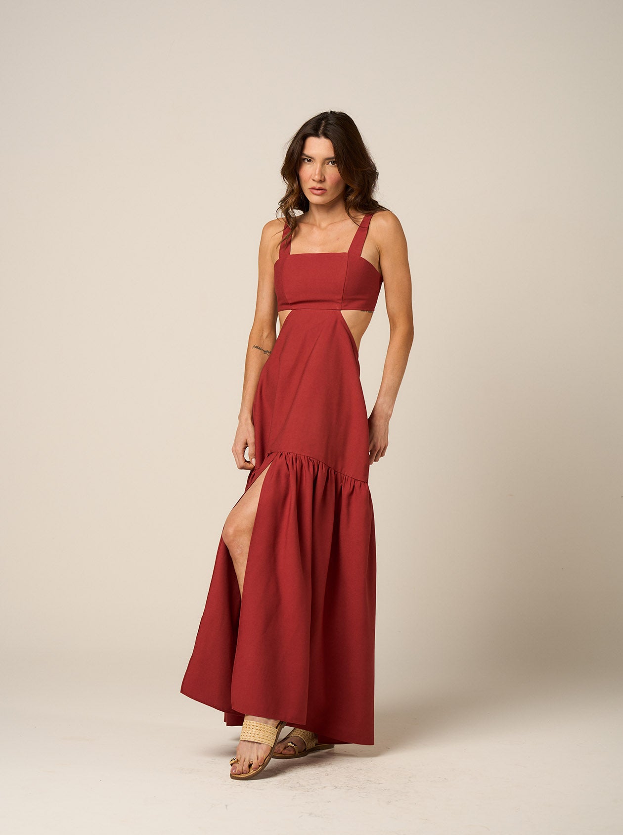 Model wearing pink maxi dress with open lace-up back and side cutouts — Amazônia B2R Sunset Cutout Dress. Also available in Terracotta.