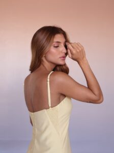 Side view of the butter yellow Soleil Linen Blend Maxi Dress featuring a front slit and elegant drape