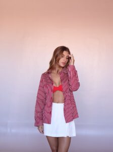 Women's oversized striped cotton shirt with rolled sleeves.