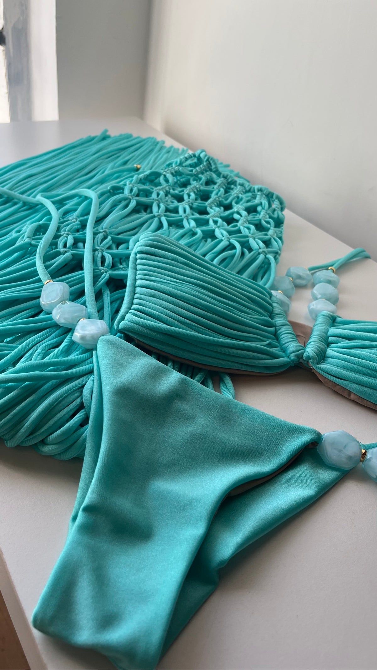 Formentera turquoise beaded halter bikini set flat lay